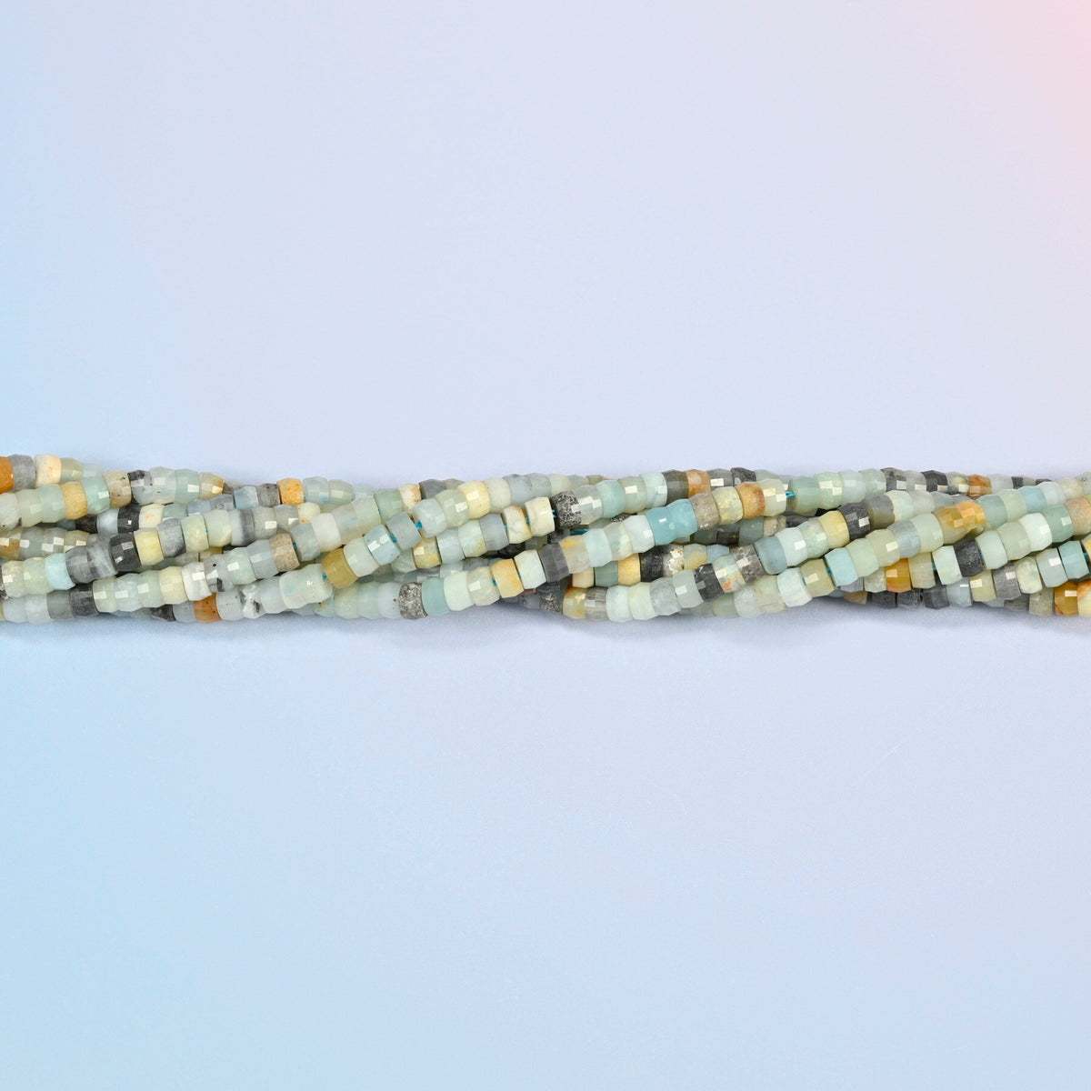 Strands of multi-color amazonite faceted heishi disc beads twisted together in a horizontal row