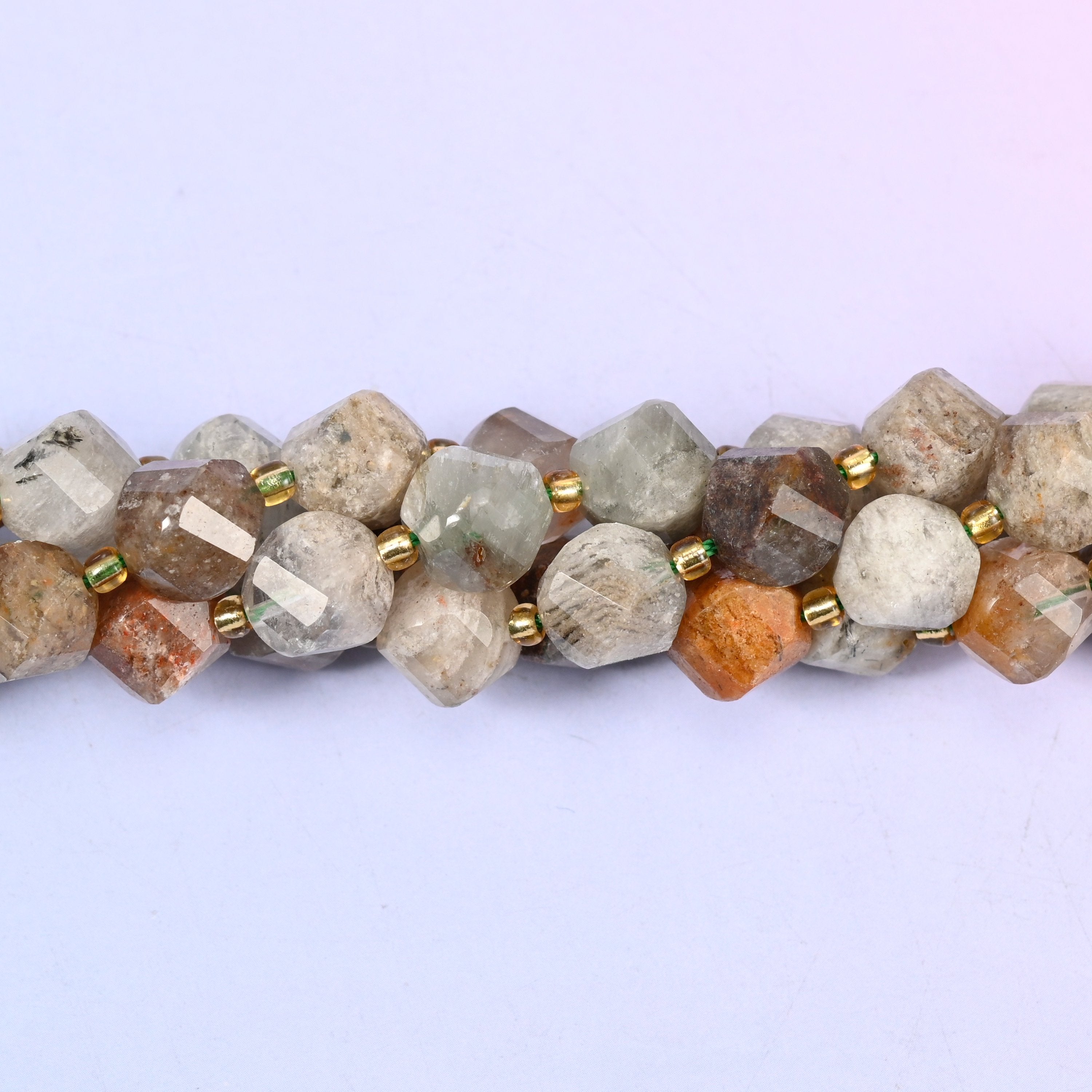 Thousand Layer Phantom Quartz natural crystal beads used as spacer or focal beads in handmade jewelry designs, 10mm
