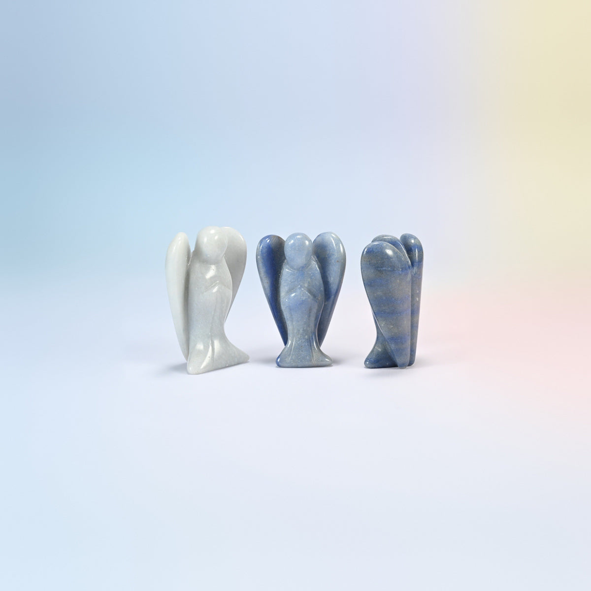 Three natural blue aventurine guardian angel carvings, blue with a soft shimmer, one lighter, 2 inch