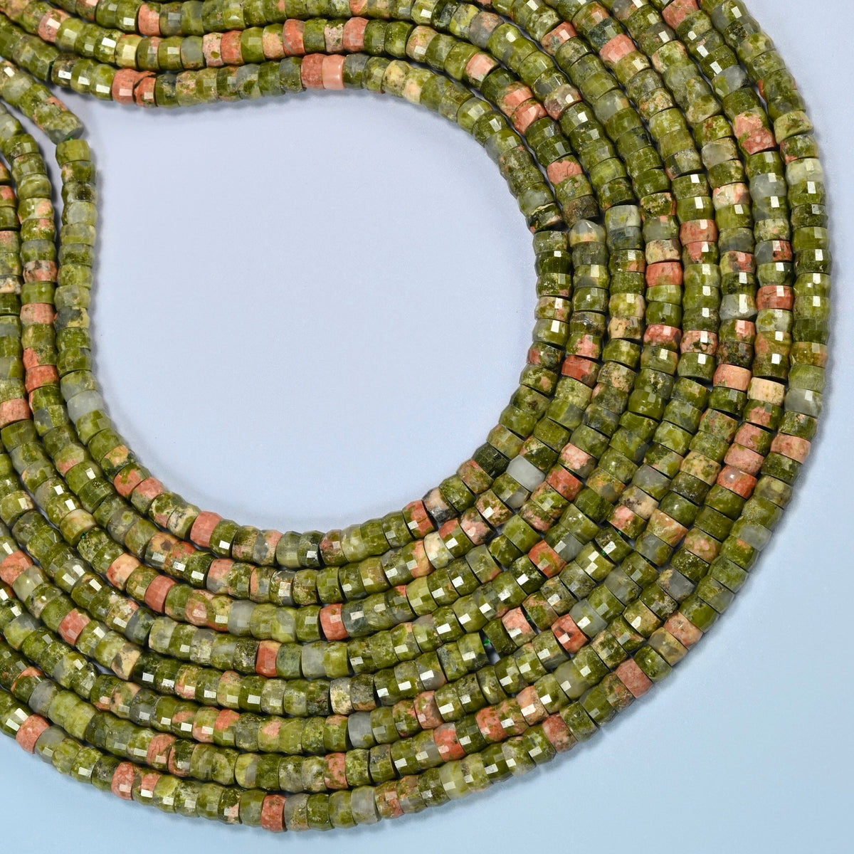Unakite faceted heishi disc beads curved into an open loop, olive green and pink beads