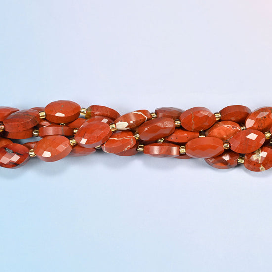 Strands of flower red jasper faceted flat oval beads twisted together in a horizontal row