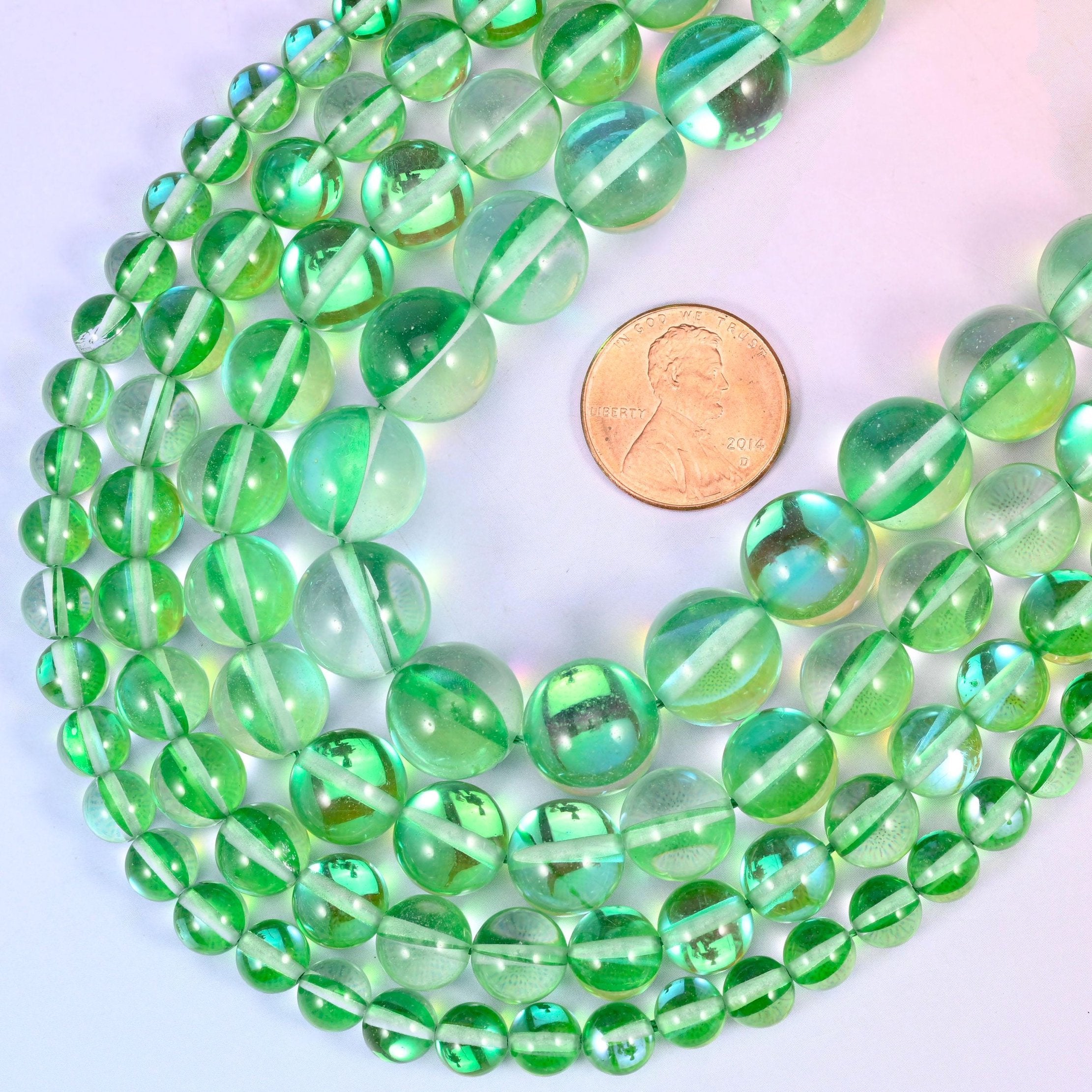 Round iridescent green glass beads with mirrored aura coating