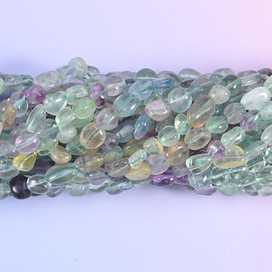 Close macro of fluorite pebbles showing green, yellow and violet colour zoning