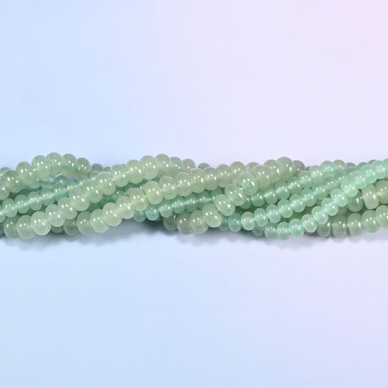 Green Aventurine gemstone rondelle beads twisted together, showing how the discs stack into a ribbed line