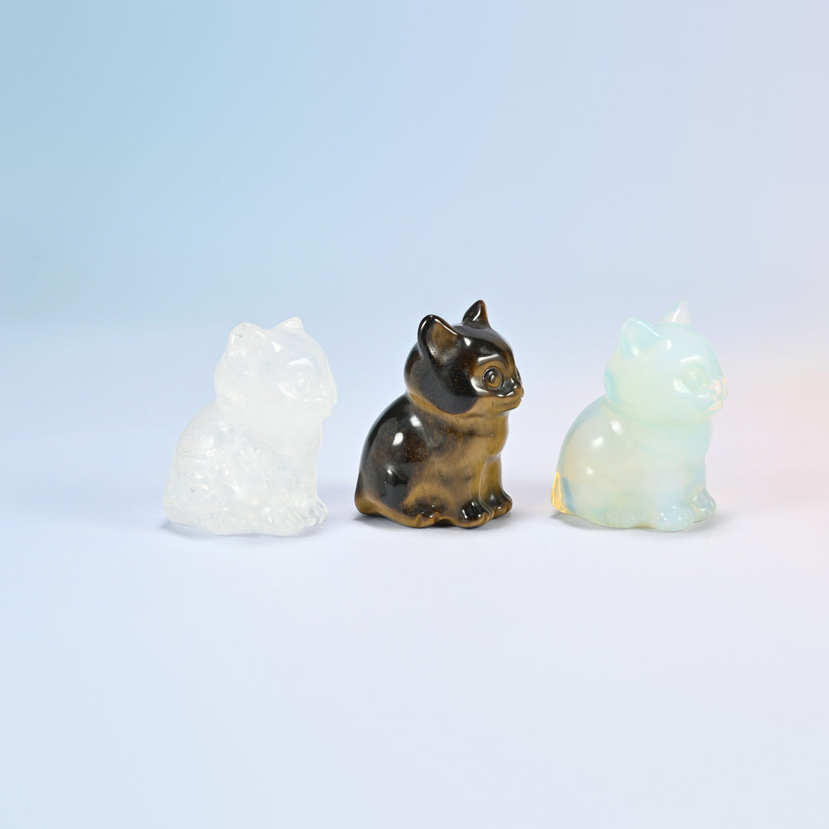 Three big eyed kitten crystal carvings turned to the side