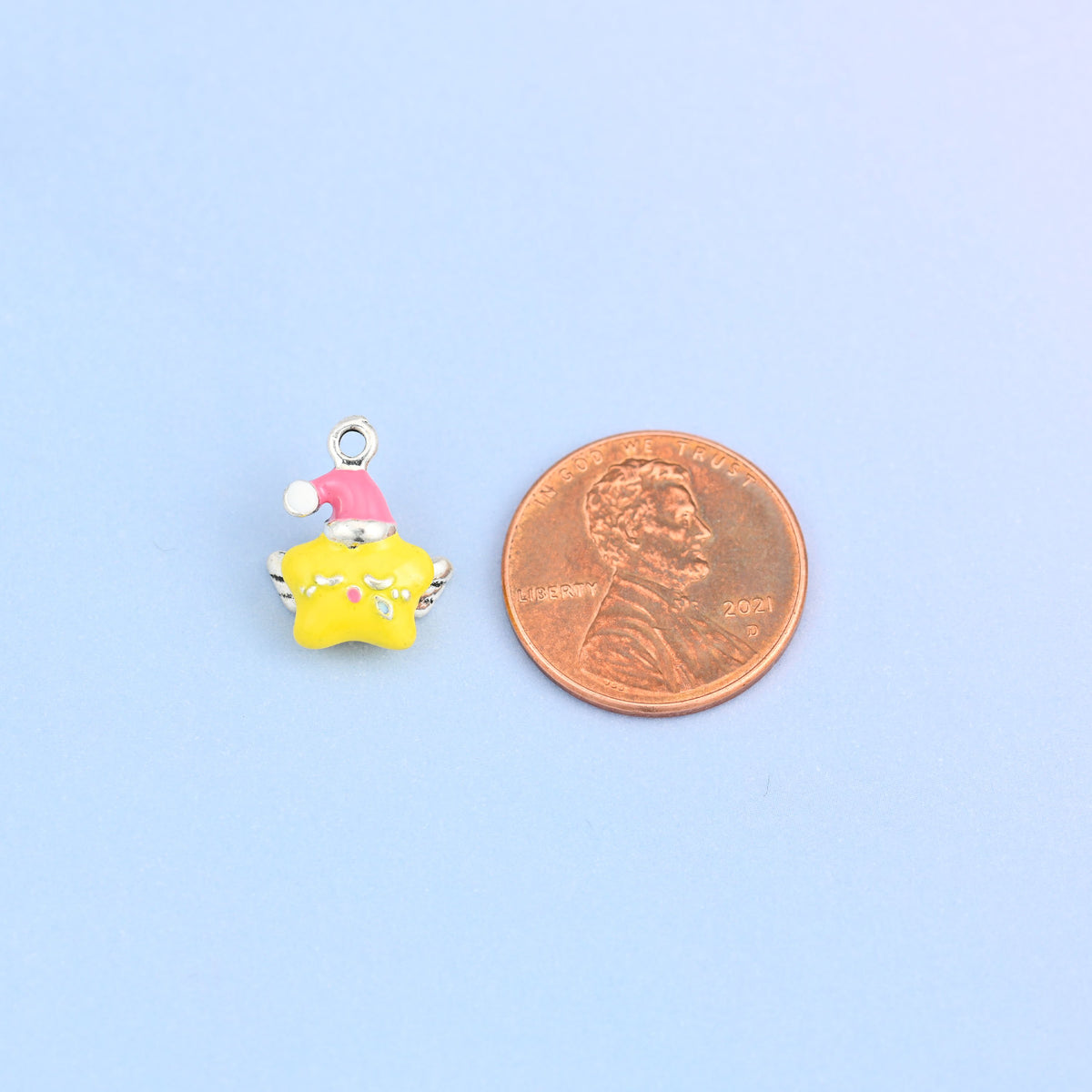Single star charm with wings shown for scale at 14 x 11.35mm, yellow enamel over 18K white gold plated brass.