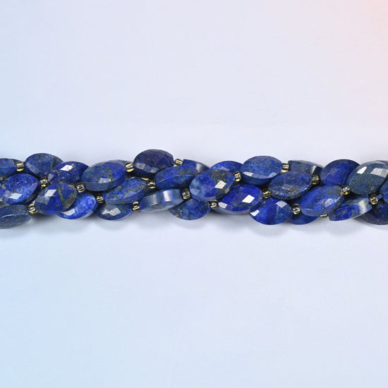 Strands of lapis lazuli faceted flat oval beads twisted together in a horizontal row