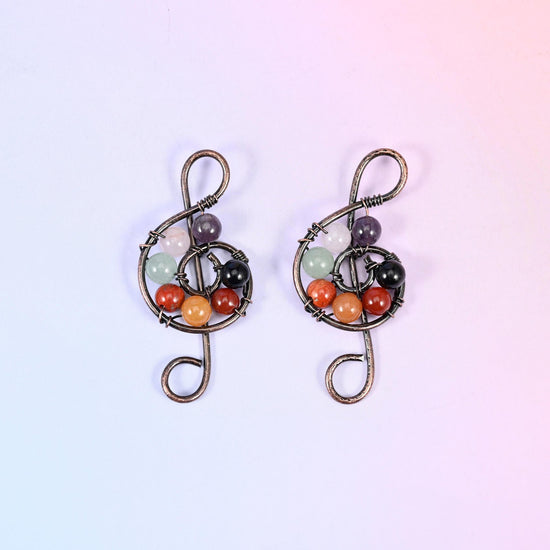 Treble Clef Music Symbol Pendant, brass wire bent into a treble clef wound around a cluster of 6mm gemstone rounds