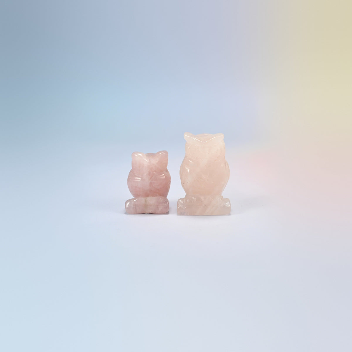 Owl crystal carving in rose quartz, light pink natural stone