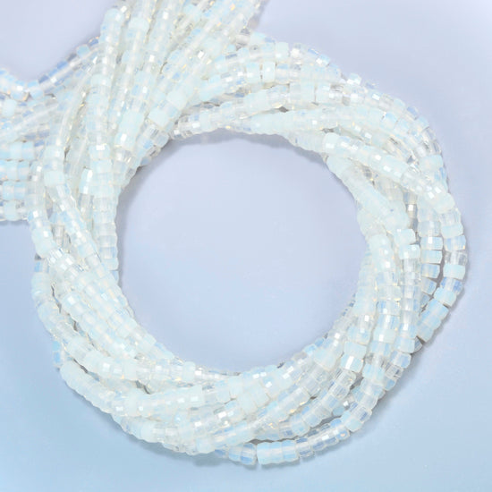 Opalite faceted heishi disc beads coiled into overlapping loops, whole strands of milky white glass