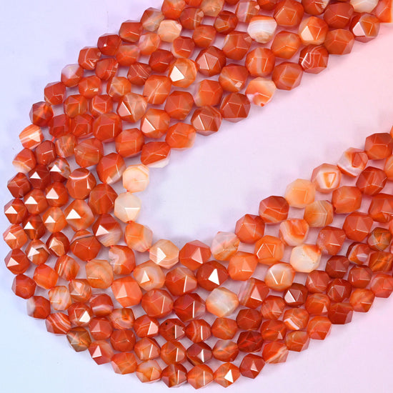 Dyed Red Stripe Agate diamond star cut beads, strands crossing in a V, dyed red holding an even tone over natural white agate bands