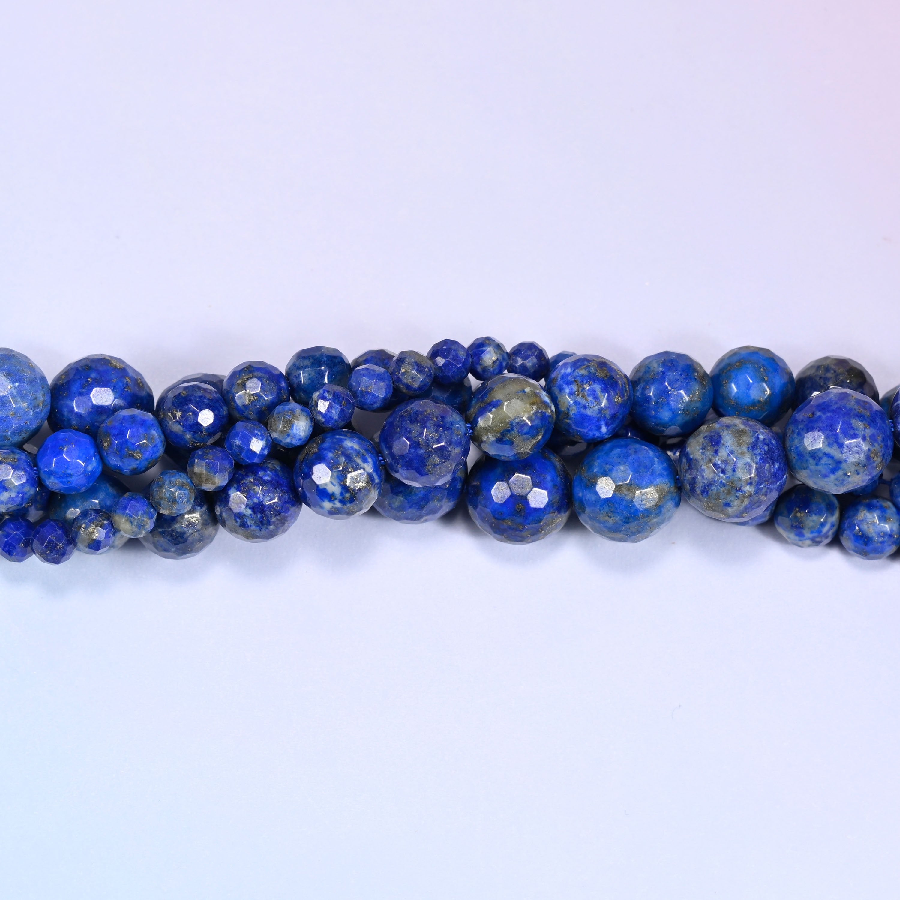 Lapis Lazuli faceted beads with a polished faceted finish that catches the light.
