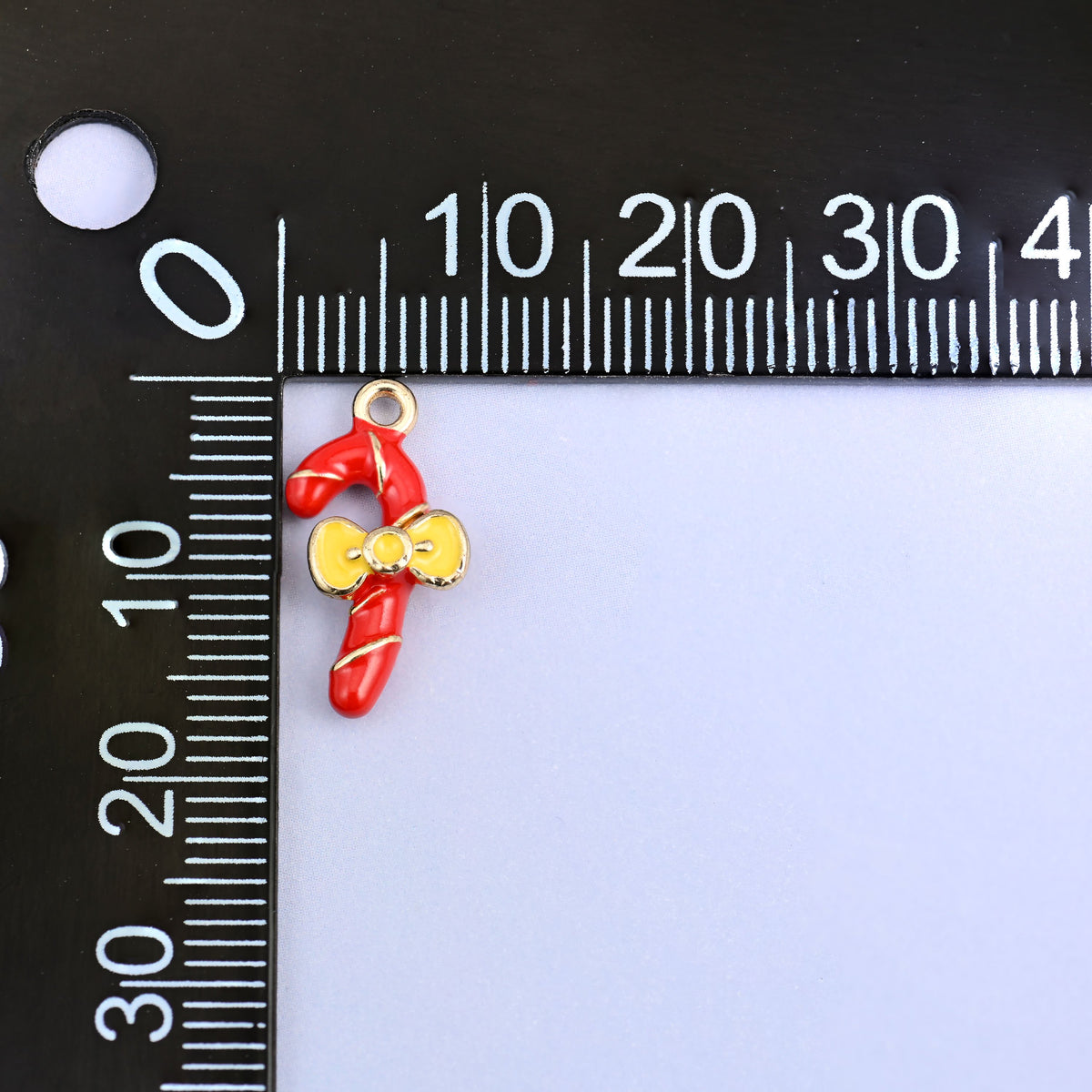 Candy cane charm measuring 17.16 x 8.46mm, small enough for a bracelet or an earring.