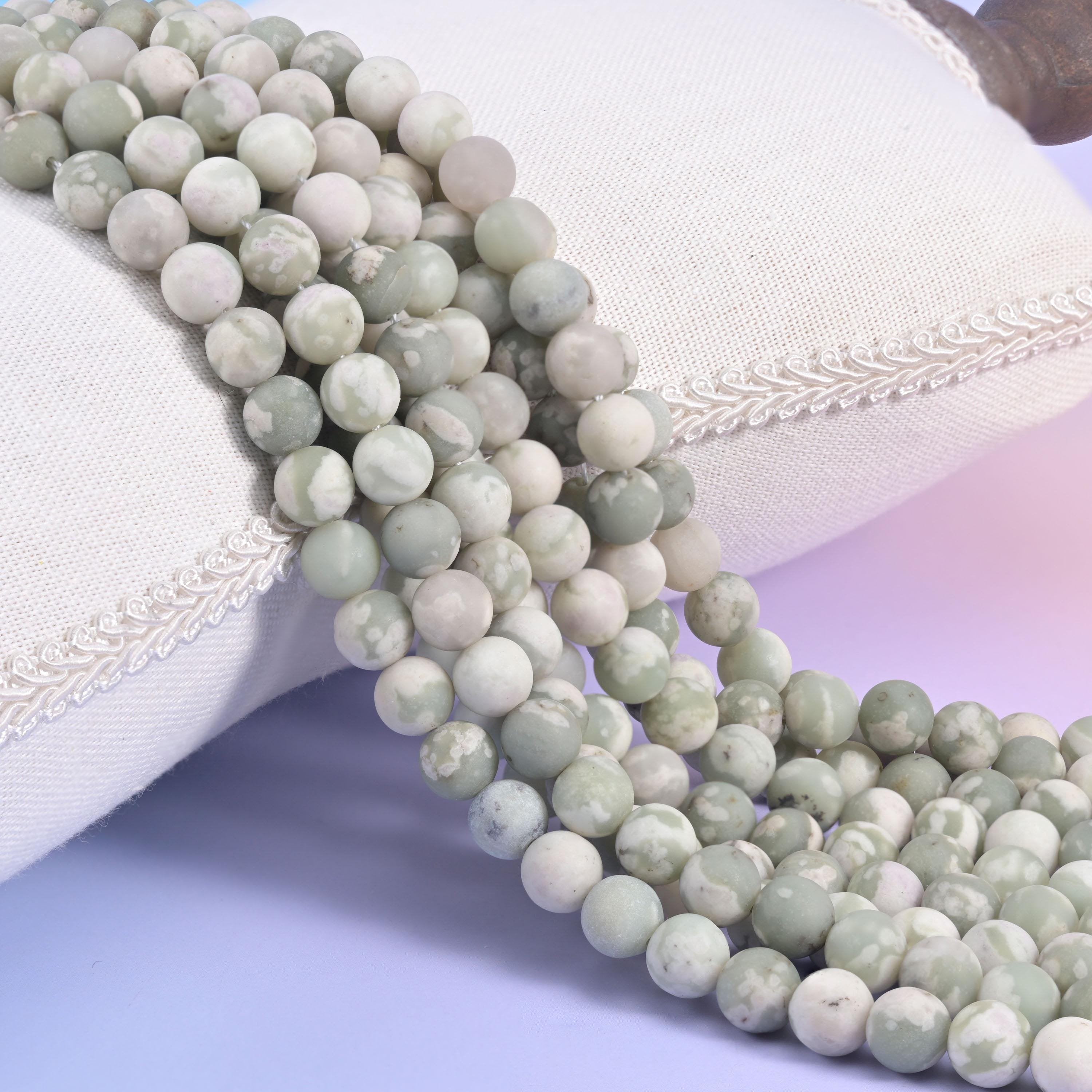 Pale sage green Peace Jasper matte round beads with a chalky off-white, frosted finish