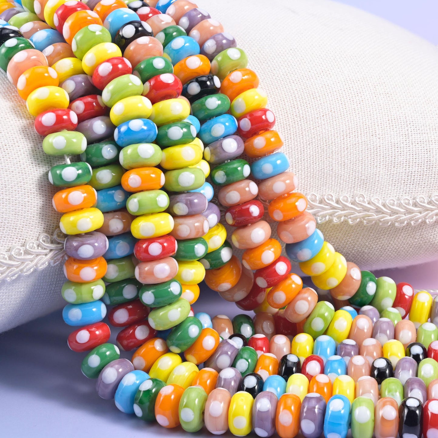 Multi-Color Donut Glass Beads in tomato red, sunflower yellow, orange, green and blue with a white dot pattern