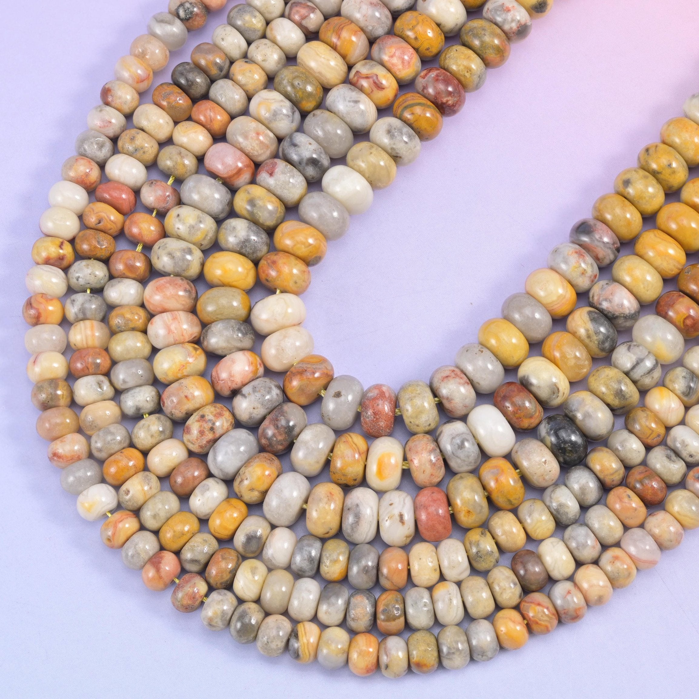 Rondelle cut Crazy Lace Agate beads with a smooth polished finish