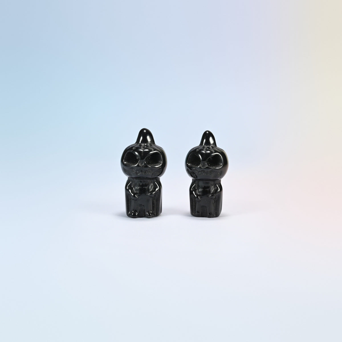 Two natural black obsidian pumpkin skull carvings with a glossy black polish, 1.8 inch