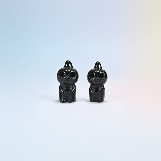 Two natural black obsidian pumpkin skull carvings with a glossy black polish, 1.8 inch