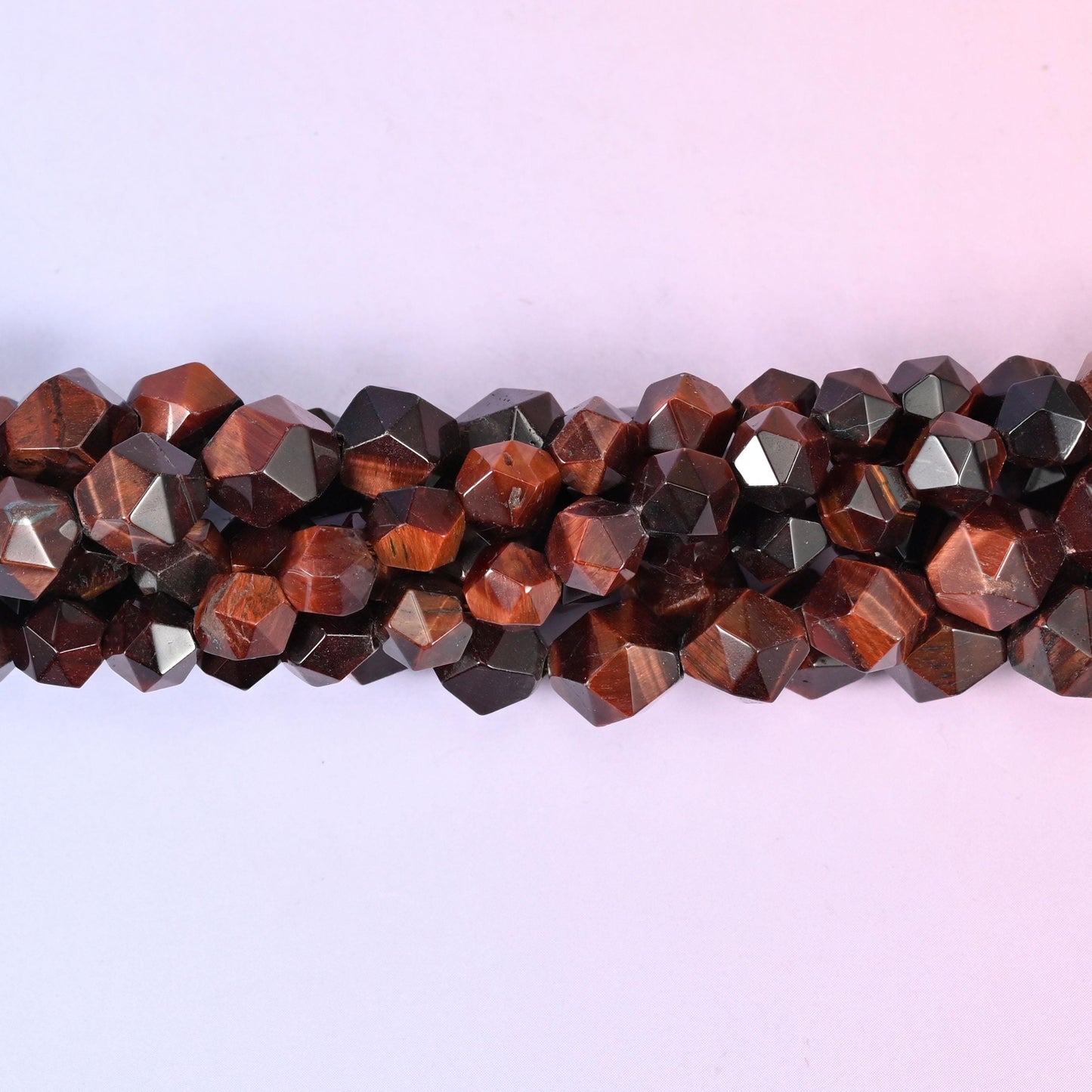 Natural Red Tiger Eye gemstone beads with chatoyant shimmer and a faceted star cut