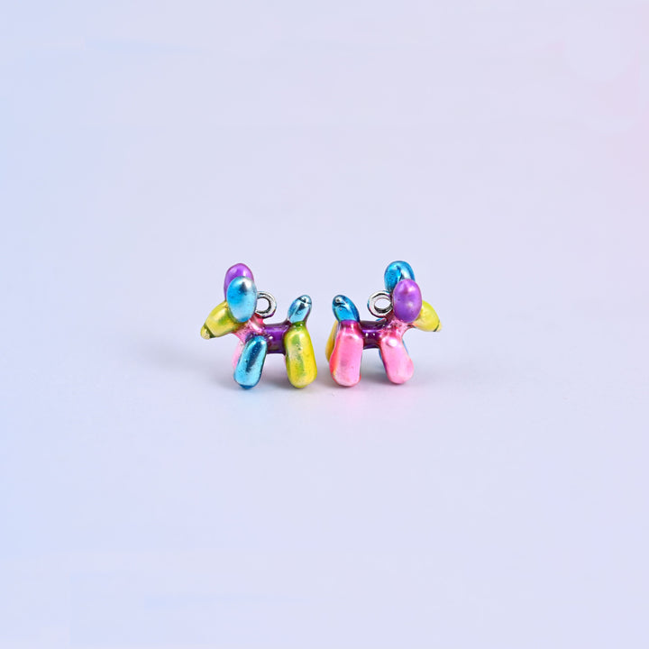 Balloon dog charms seen from the front, the twisted balloon body moulded in blue, purple, pink and yellow enamel.