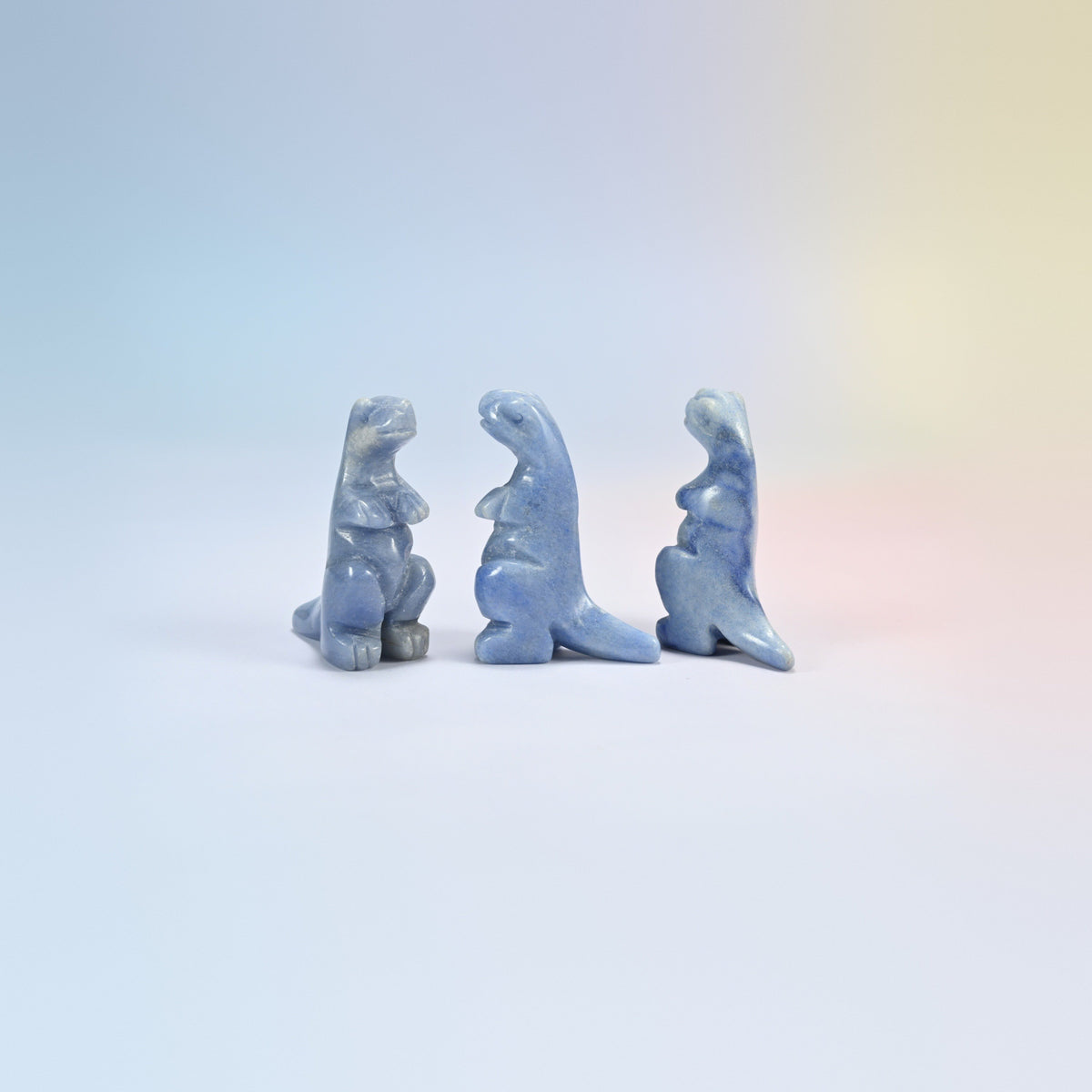Three blue aventurine T-Rex dinosaur crystal carvings, 2 inch, soft blue natural stone with fine sparkle