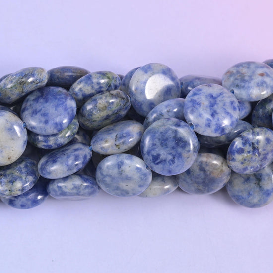 Macro of blue spot jasper coins, powder blue and green mottling over a chalky white base