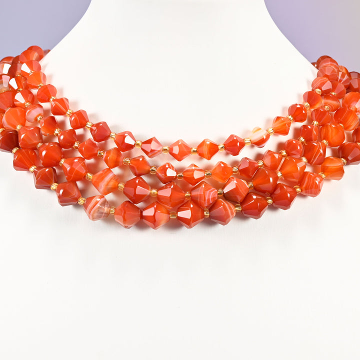 Dyed Red Strip Agate bicone bead strand worn as a multi-strand choker on a display neck form.