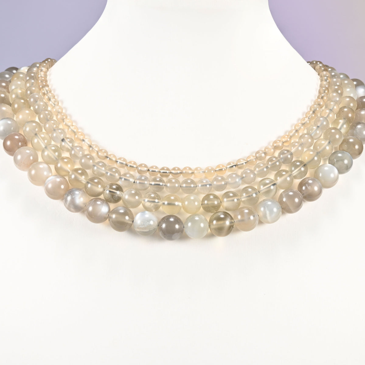 AAA Gray Labradorite smooth round beads layered as a collar, several strands showing the 4mm through 10mm sizes