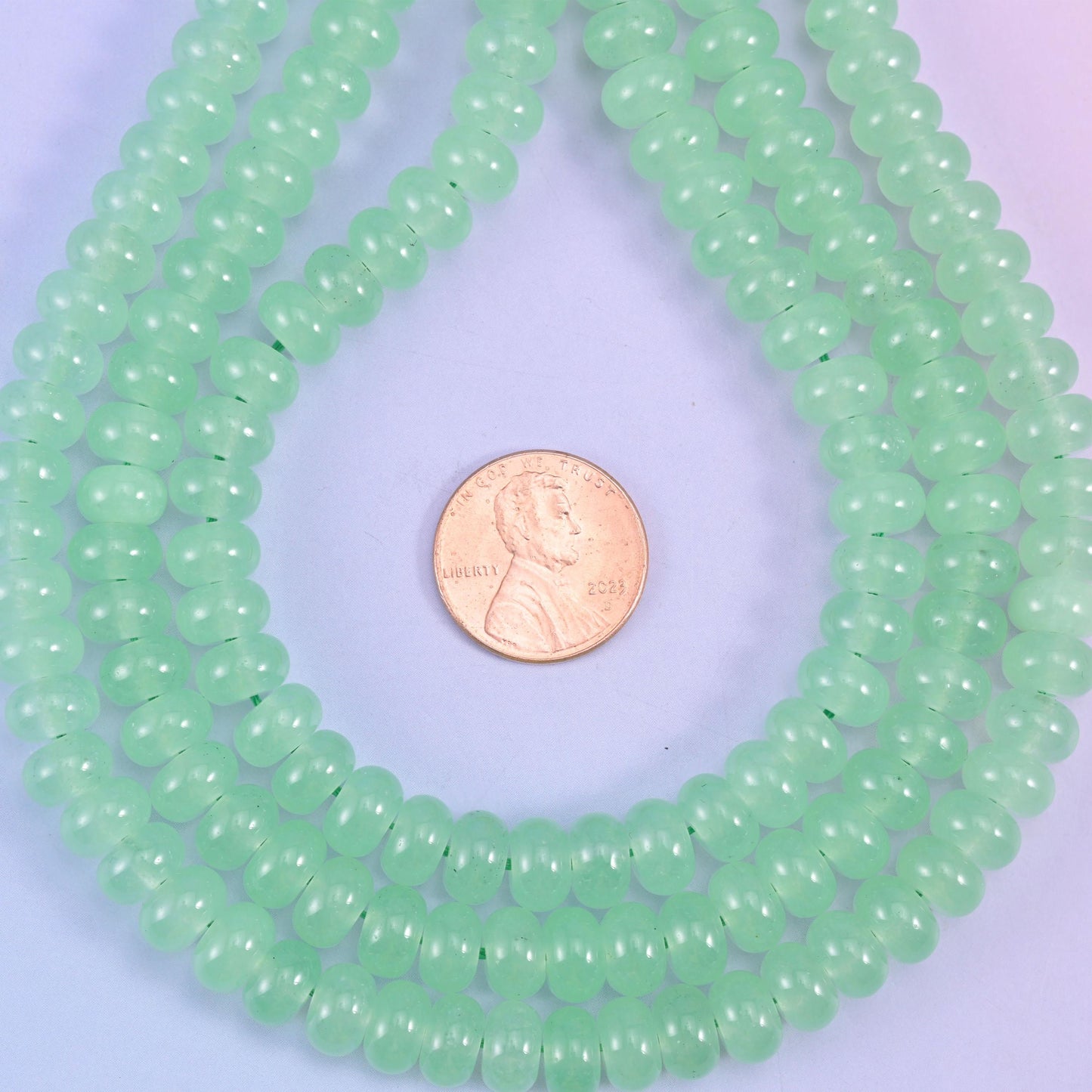 Light Green Dyed Jade Smooth Rondelle Beads, soft apple green with a waxy, faintly translucent body and an even glossy polish