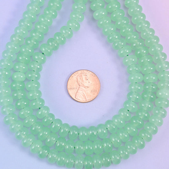 Light Green Dyed Jade Smooth Rondelle Beads, soft apple green with a waxy, faintly translucent body and an even glossy polish