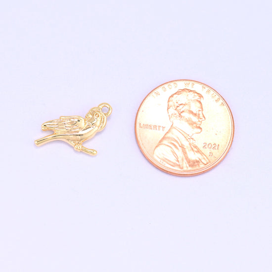 Small gold charms bird shown beside a US penny for scale, 18K gold plated 15.9x9.1mm charm