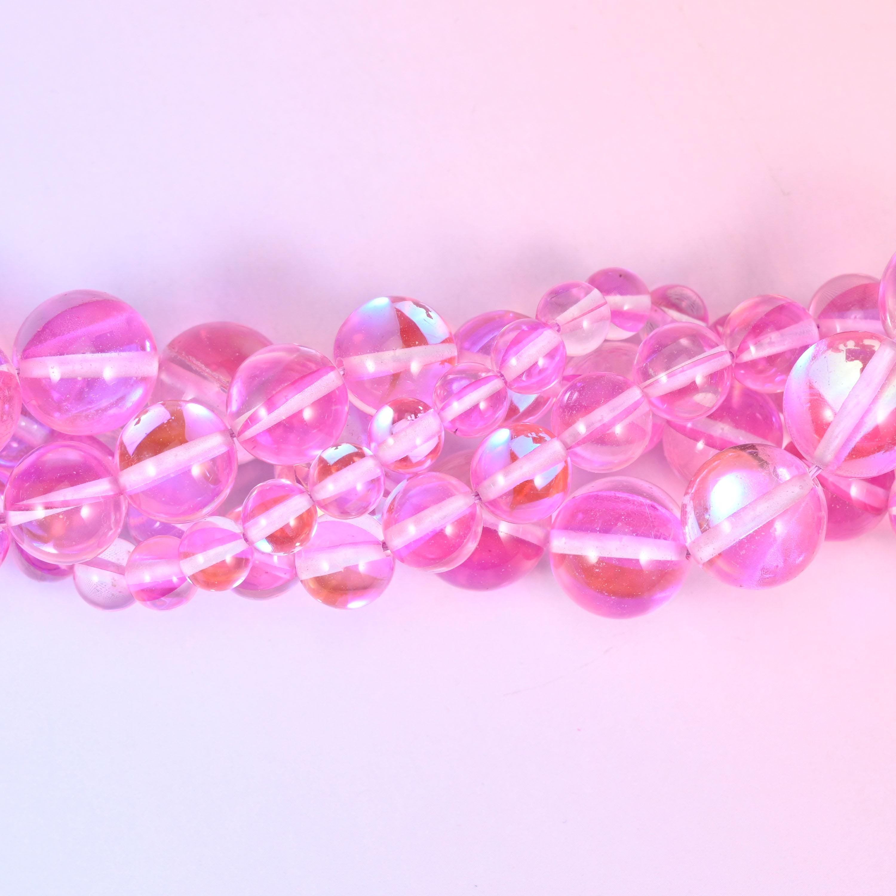 Clear bubblegum-pink glass beads finished with an iridescent aura coating
