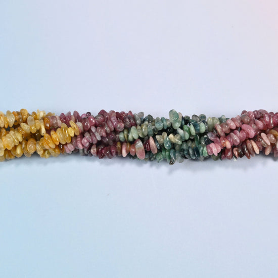 Strands of multicolor tourmaline chip beads twisted together in a horizontal row