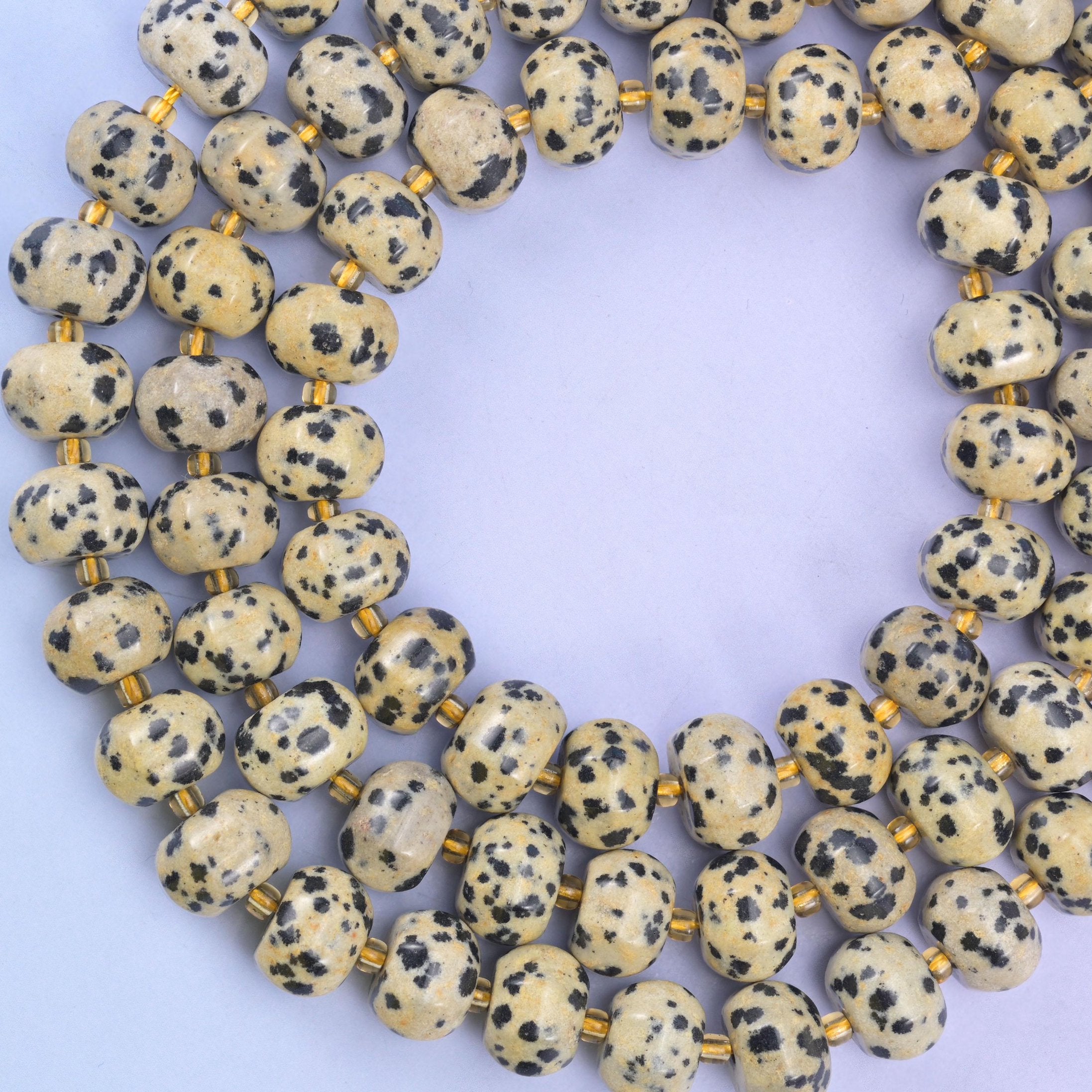 Dalmatian jasper pumpkin beads, approximately 35 beads per strand