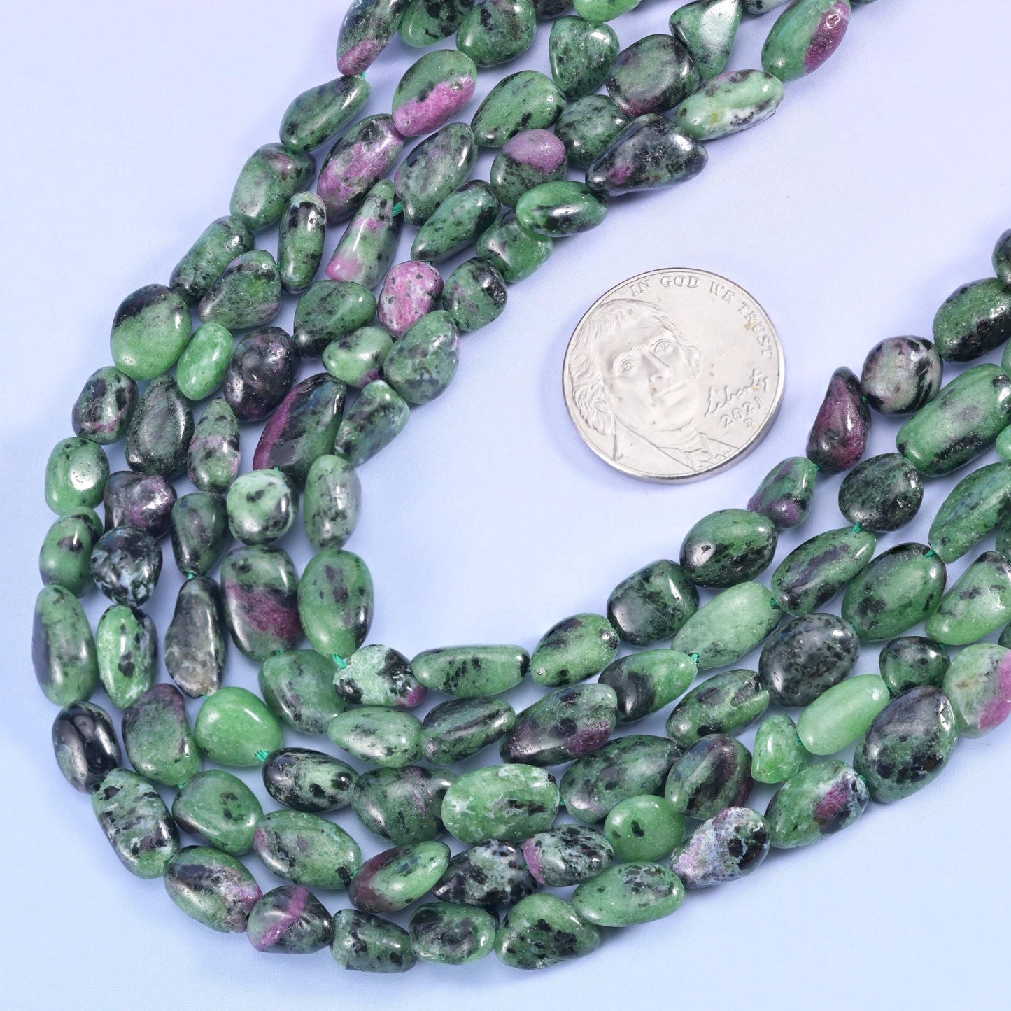 Ruby zoisite nuggets in apple green with pink ruby flecks