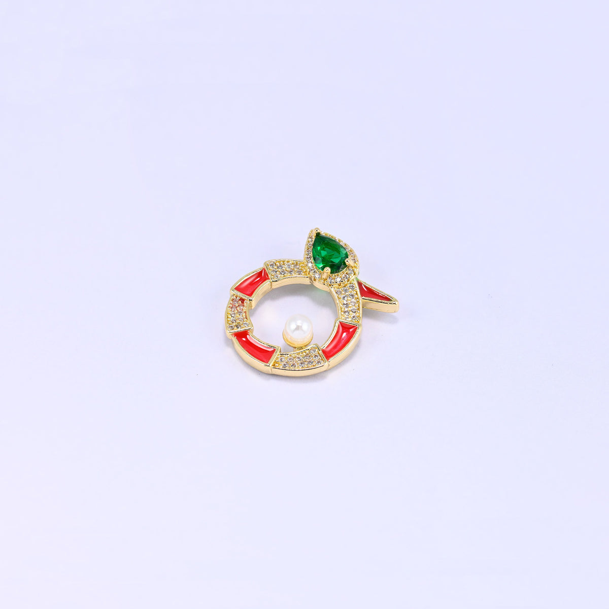 Single round snake charm on lavender, the coiled gold body banded in red enamel and clear zircon with a small pearl set inside the ring.