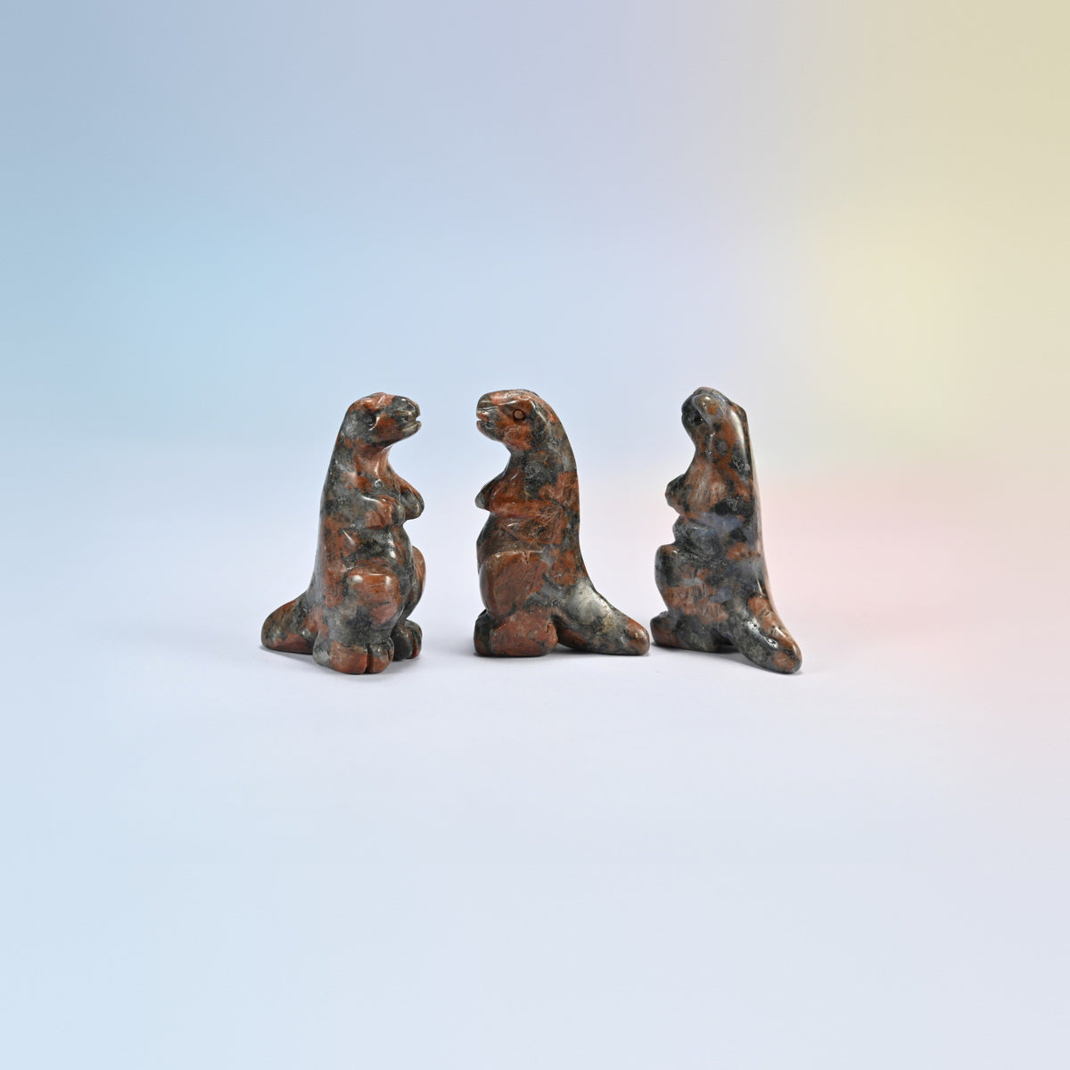 Three red labradorite T-Rex dinosaur crystal carvings, 2 inch, red-brown and gray natural stone