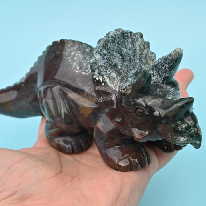 Indian Agate Triceratops Dinosaur Carving in deep mossy green with chocolate and rust-red panels.