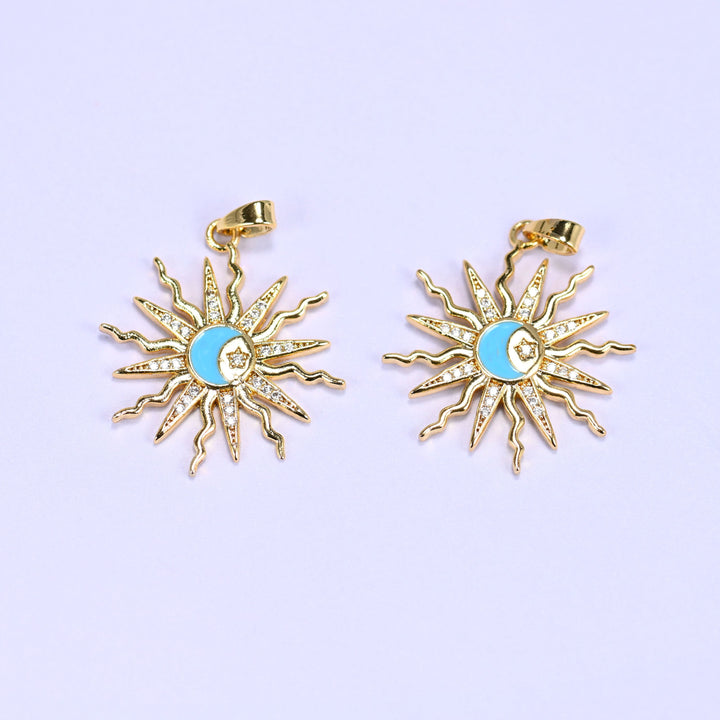 Enamel moon sun zirconia charms in blue, two gold sunburst pendants with pave rays circling a blue enamel crescent moon and star.