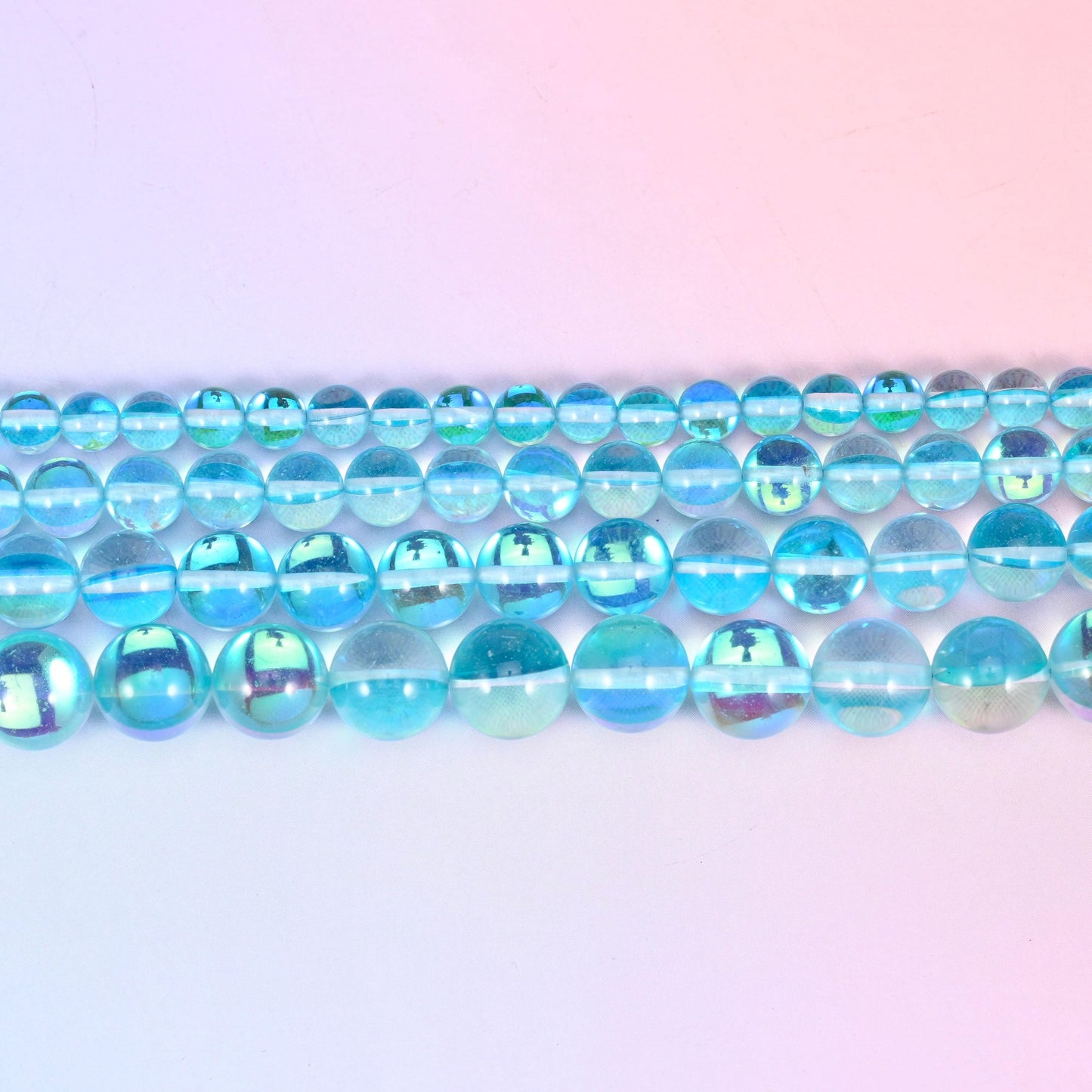 Iridescent Light Blue Round Glass Beads in clear aqua and sky blue with a green-blue rainbow flash