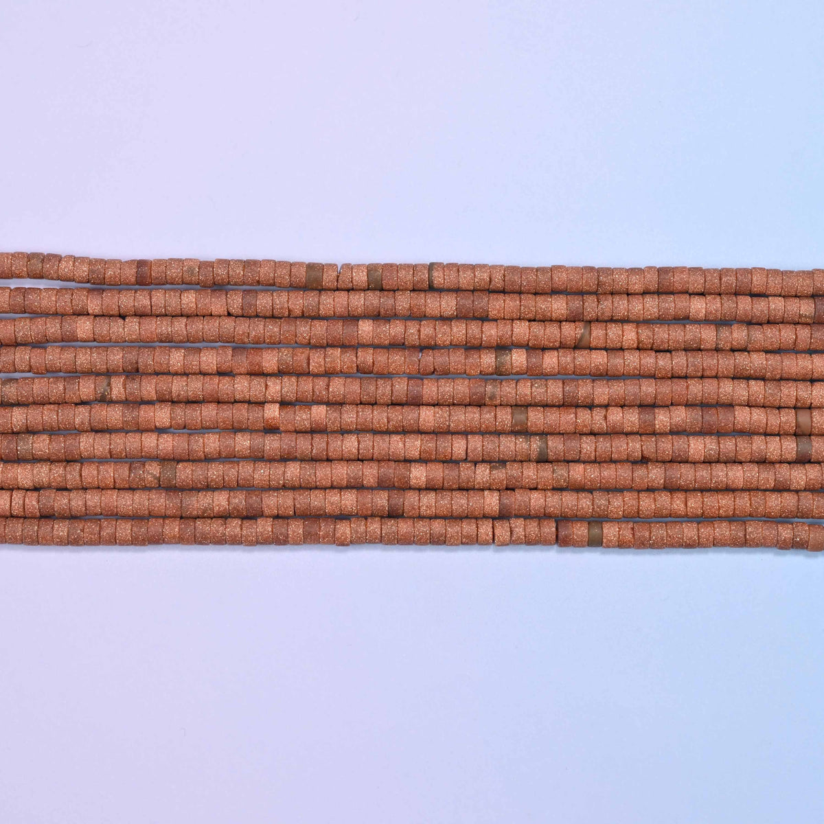 Gold sandstone beads in warm brown with shimmering copper flecks