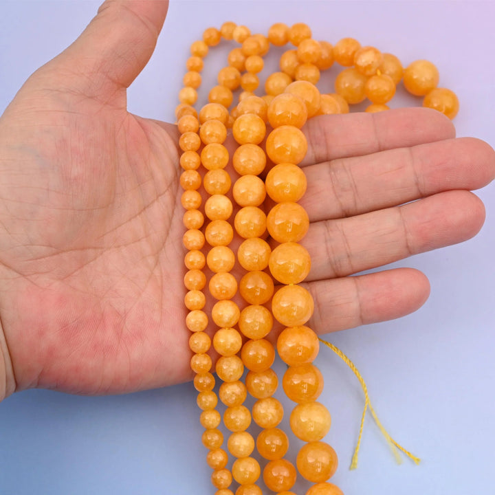 Dyed Jade beads, round, 6mm to 12mm, cloudy yellow