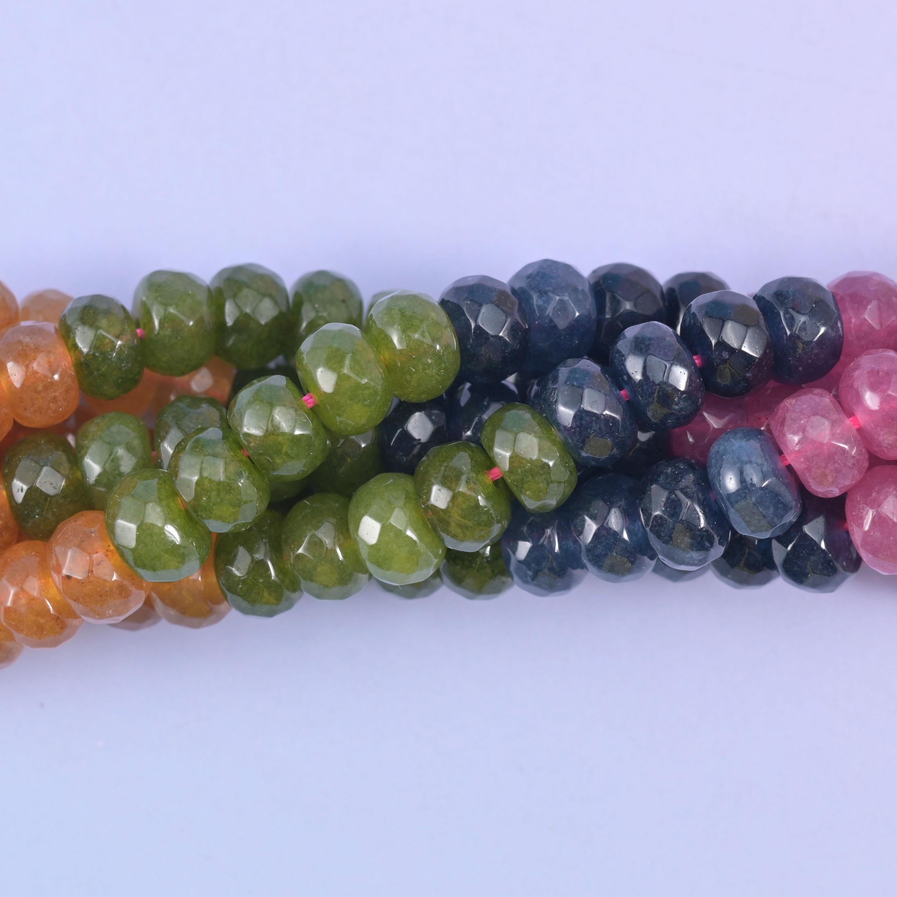 Faceted rondelle cut dyed jade beads with a graded, watermelon-tourmaline style colour run