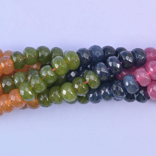 Faceted rondelle cut dyed jade beads with a graded, watermelon-tourmaline style colour run