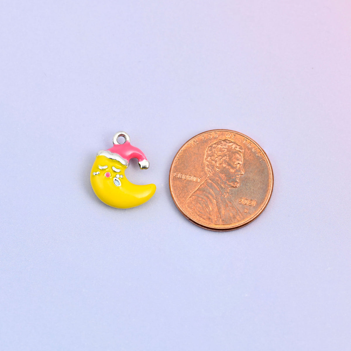 Moon charm in a red Santa hat shown at actual size, 14.24 x 11.24mm.