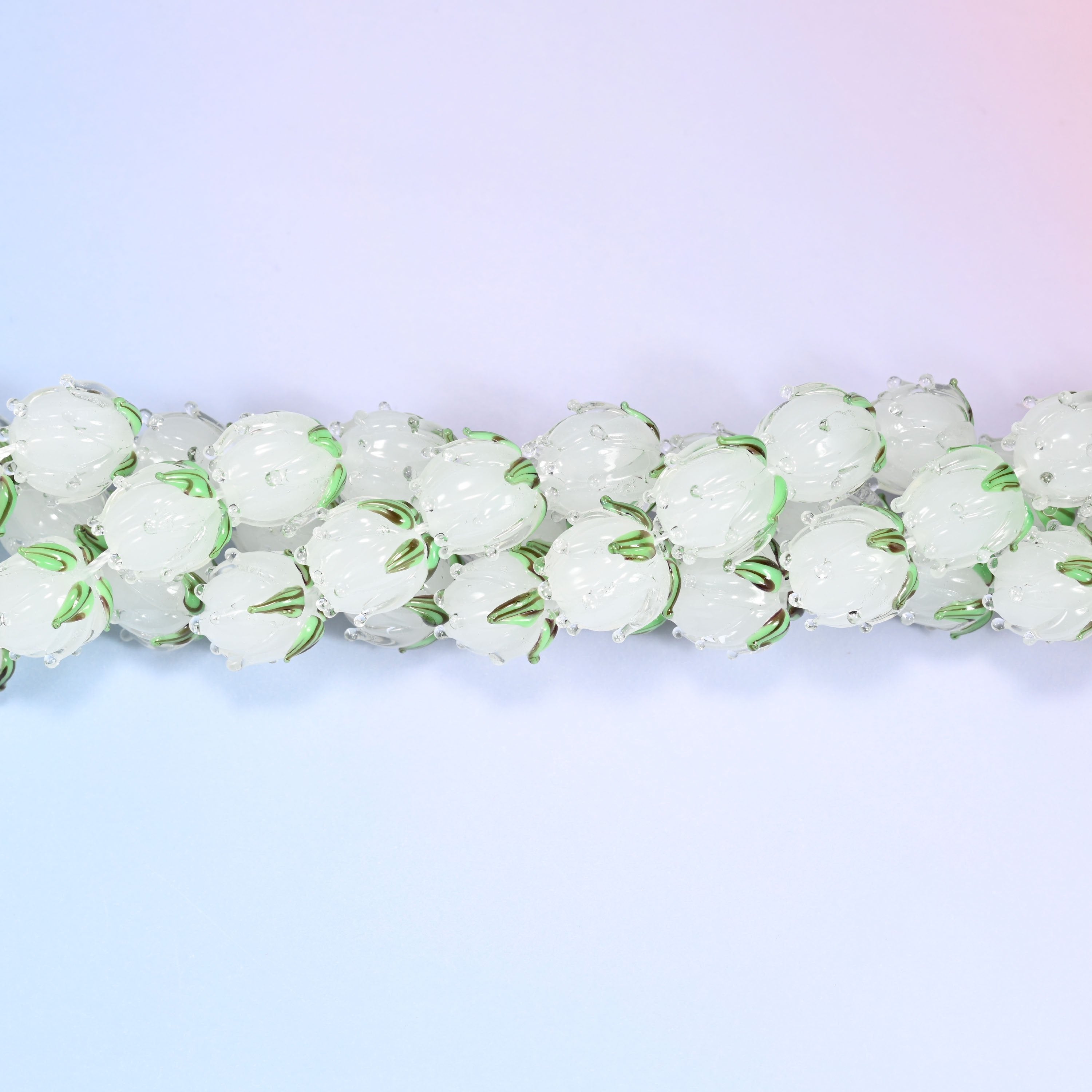 White tulip bud-shaped lampwork glass beads, frosted translucent glass with hand-formed sculpted petal detailing that gives a realistic flower bud look.