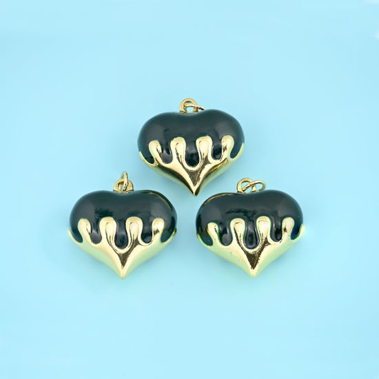 A fat domed heart in glossy enamel with polished 18K gold filled brass running down over it like poured metal. Offered…