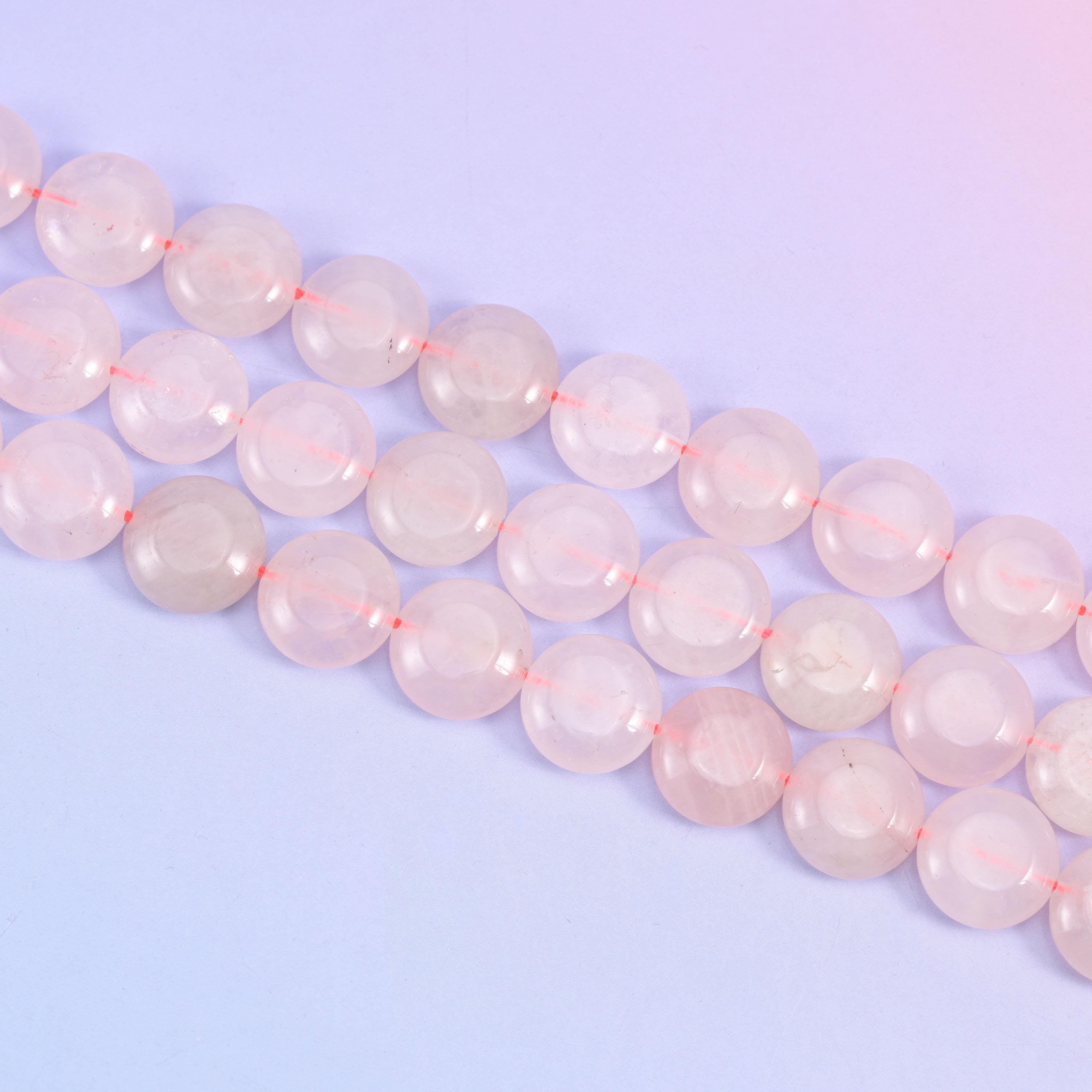 Rose Quartz coin beads with cloudy white veils drifting through the pink stone