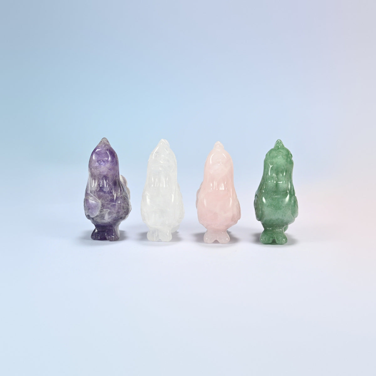 Front view of four 2 inch gemstone roosters standing in a row