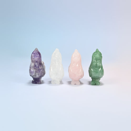 Front view of four 2 inch gemstone roosters standing in a row